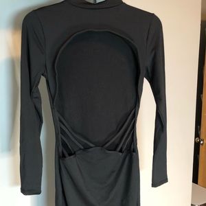 Black body con, open back, and low cut to show some extra skin